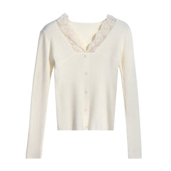 A cream-colored cardigan with lace trim and buttons, displayed against a white background.