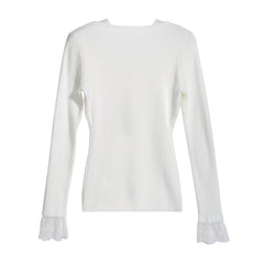 A white long-sleeved sweater with lace trim on the sleeves.