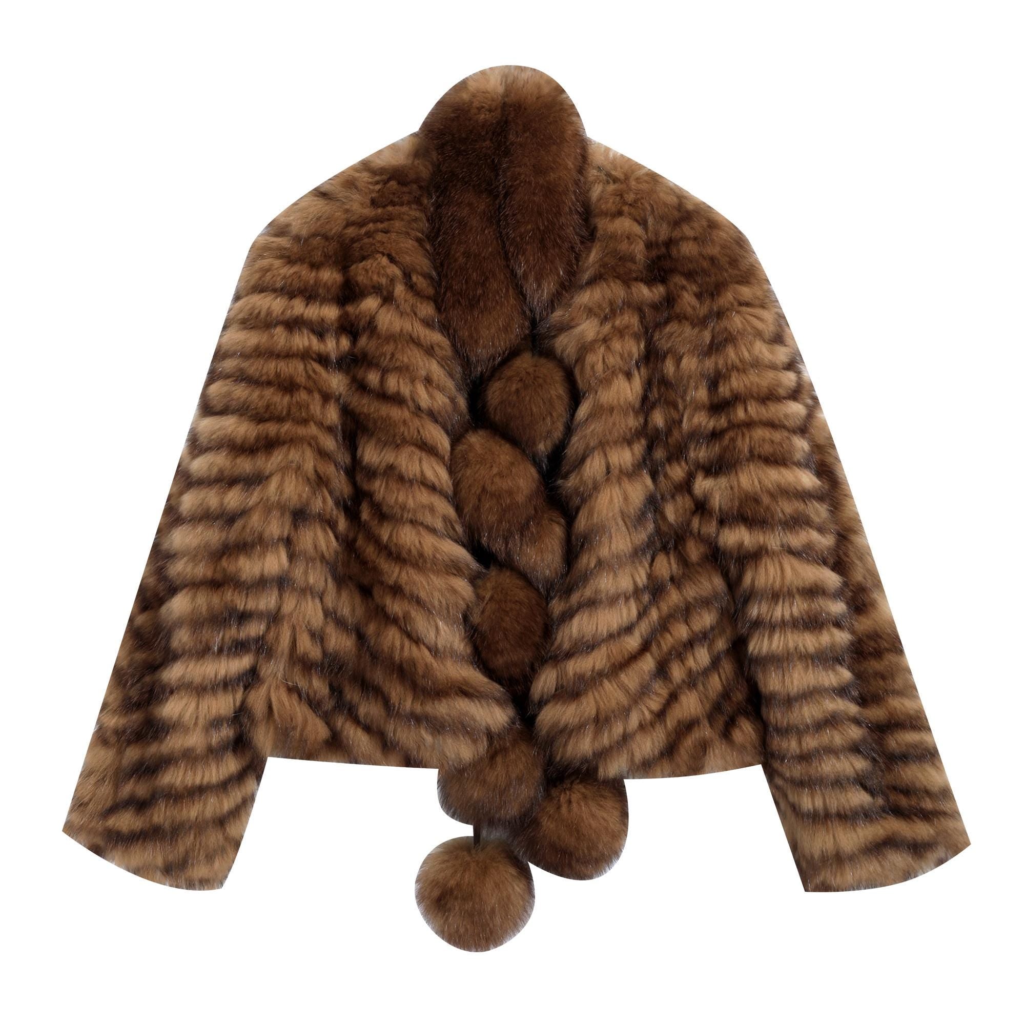 A brown fur coat with a braided collar and pom poms hanging from the bottom.