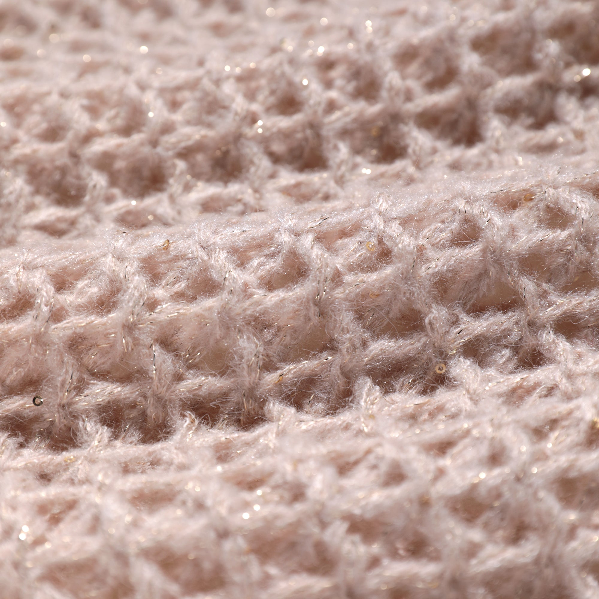 A close-up image of a soft, fuzzy fabric with a textured, woven pattern.