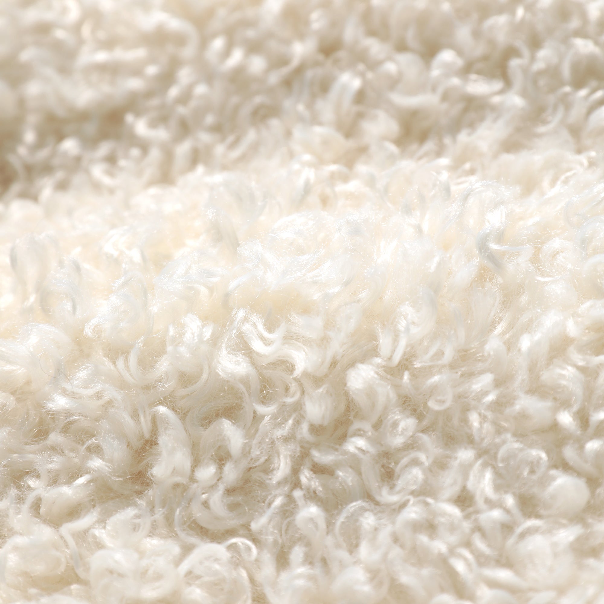 The image is a close-up of a fluffy, white material, possibly a soft fabric or a pile of cotton.