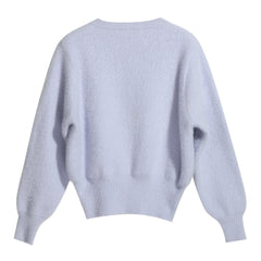 A light blue, oversized knitted sweater with long sleeves and a round neckline.