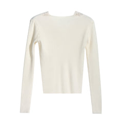 A cream-colored long-sleeved sweater with a simple, classic design.