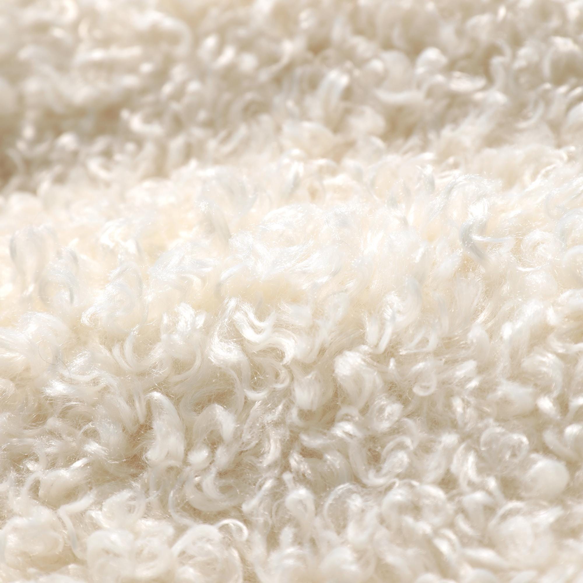The image is a close-up of a fluffy, white material, possibly a soft fabric or a pile of cotton.