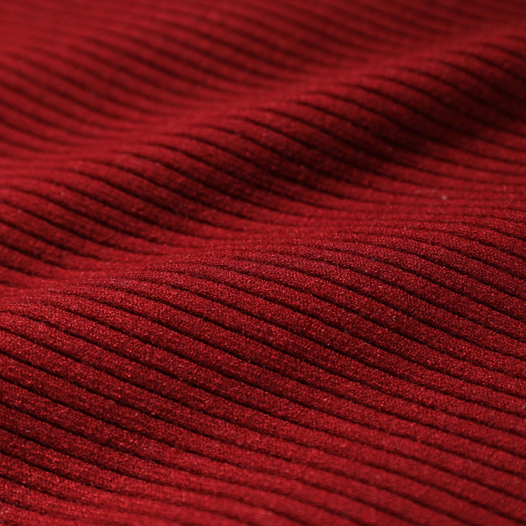 a close-up view of a red fabric with a textured, ribbed appearance.