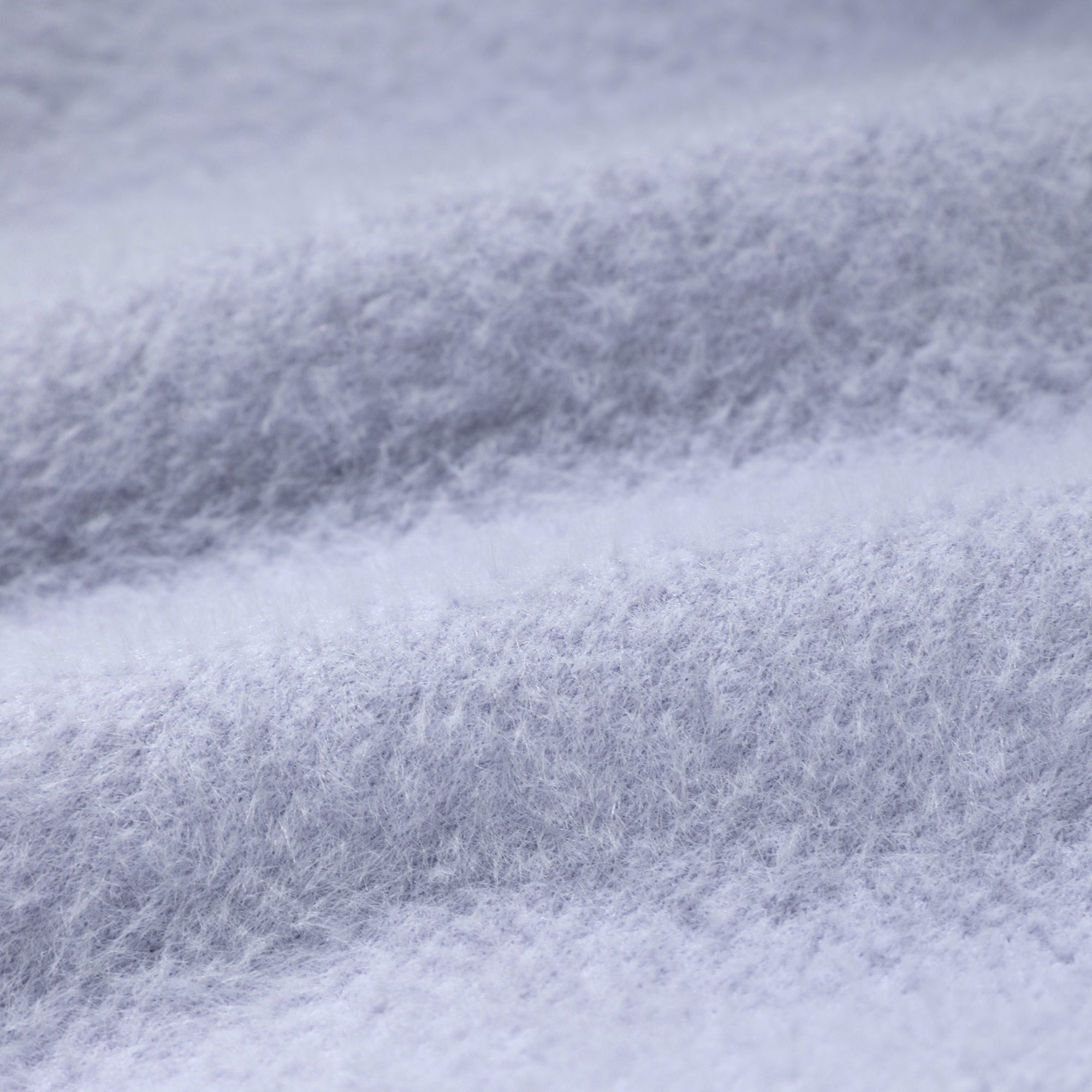 A close-up view of a soft, fluffy fabric with a textured, fuzzy appearance.