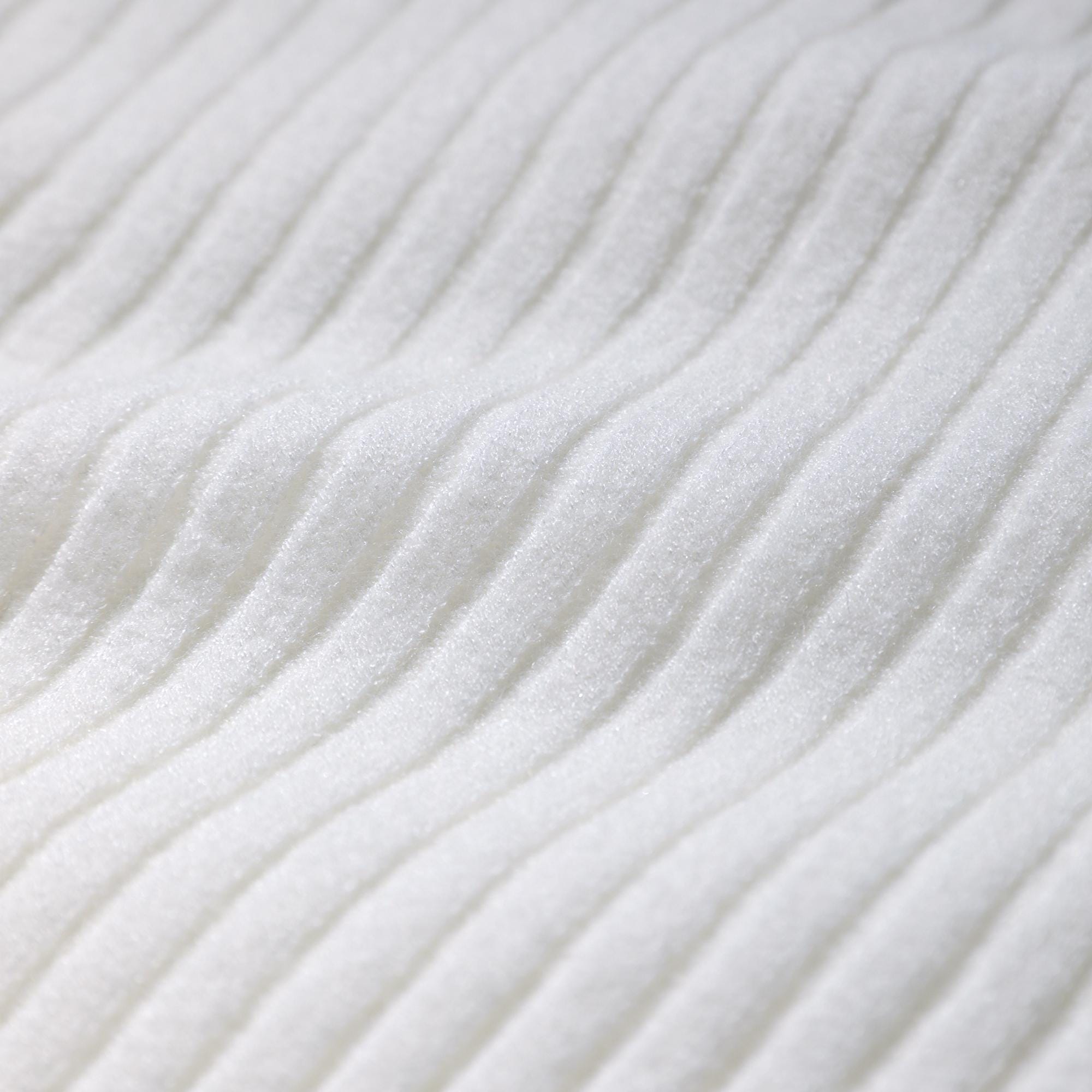 A close-up image of a white fabric with a ribbed texture, featuring a repeating diagonal pattern.