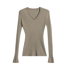A beige ribbed sweater with long sleeves and a V-neckline.