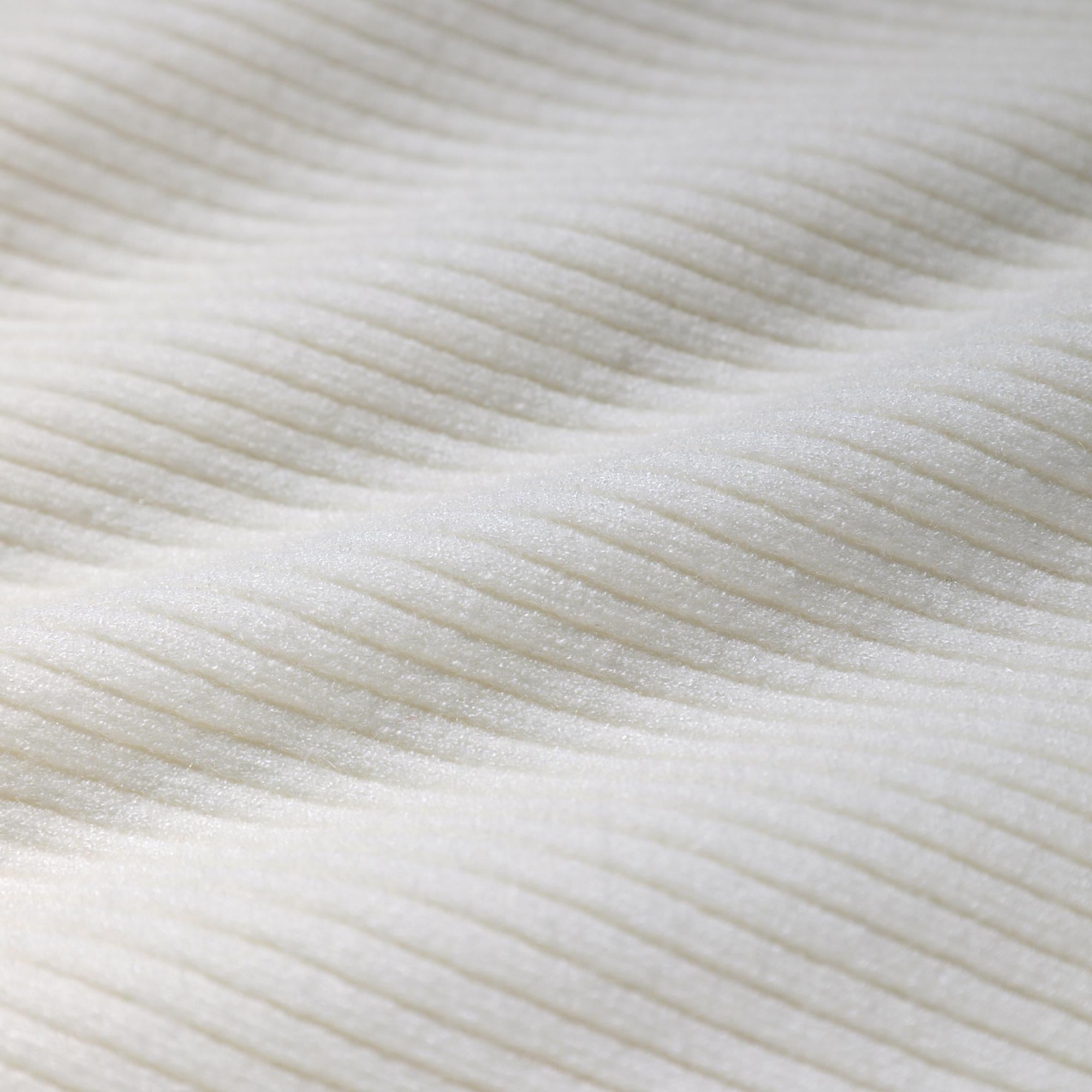 a close-up view of a white fabric with a textured, ribbed appearance.