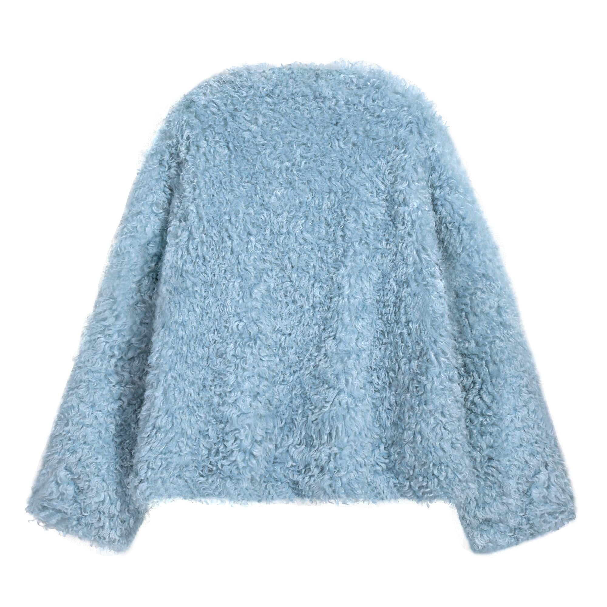 A light blue, fluffy, oversized sweater is shown against a white background.