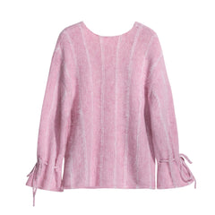 A pink knitted sweater with long sleeves and a high neckline.
