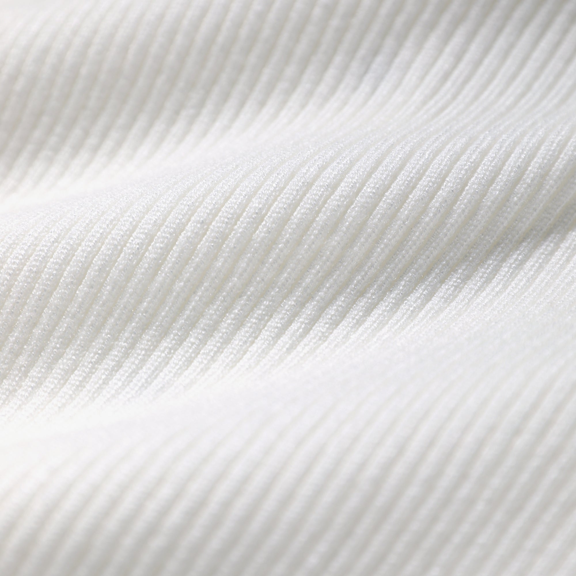 a close-up view of a white fabric with a textured, ribbed appearance.