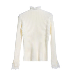 A white long-sleeved sweater with a ruffled collar and lace trim on the sleeves.