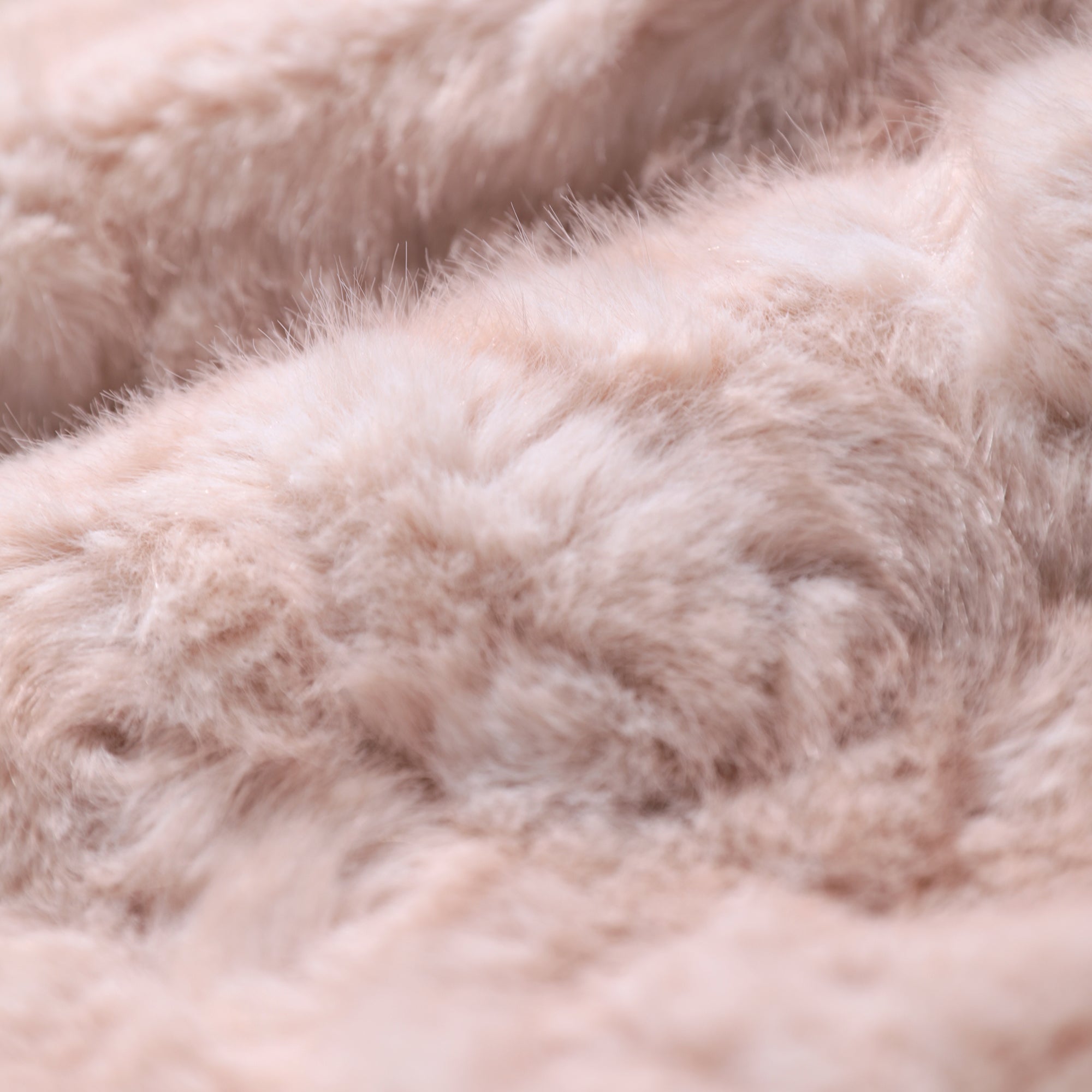 A close-up image of a soft, fluffy, and textured fabric, likely a type of fur or plush material.