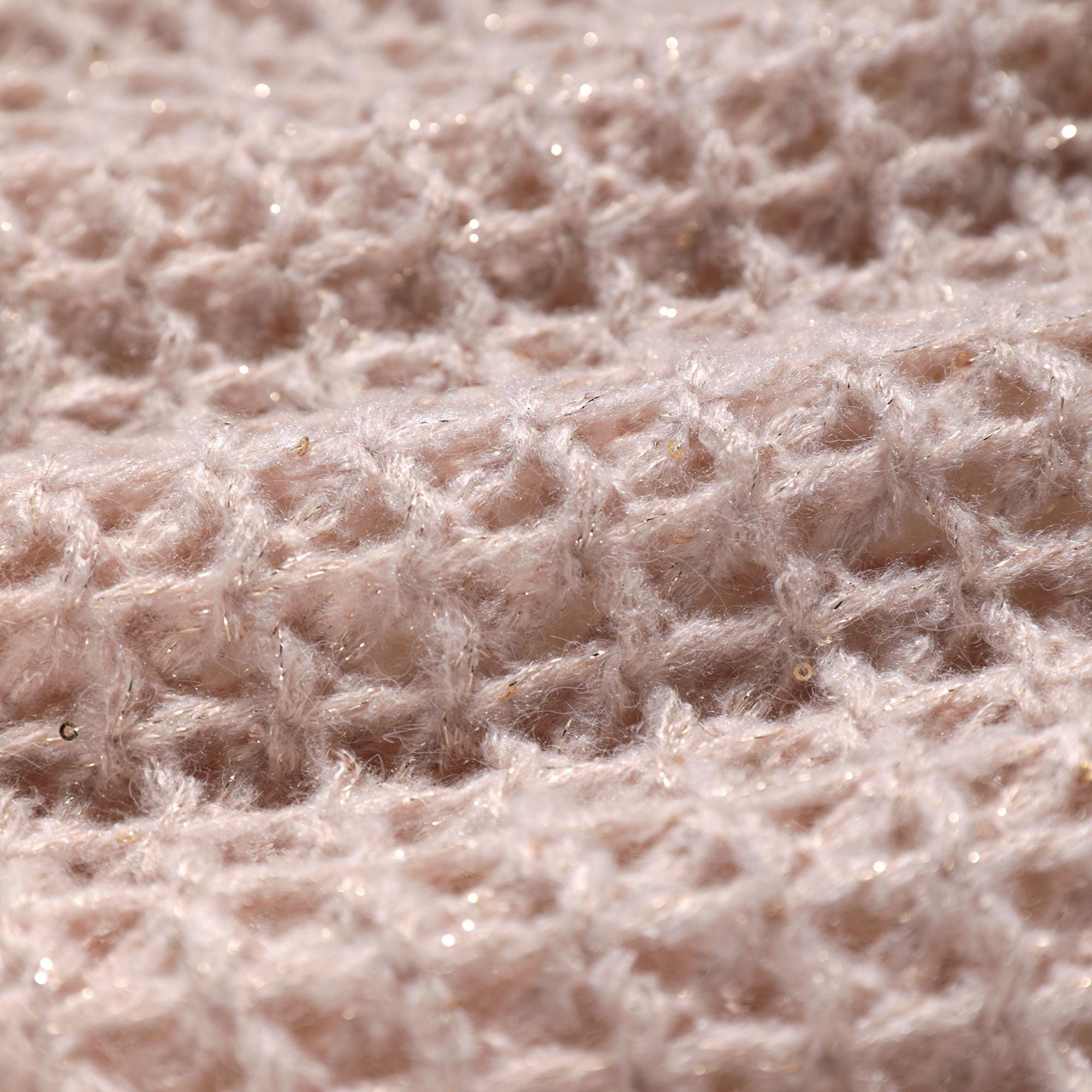 A close-up image of a soft, fuzzy fabric with a textured, woven pattern.