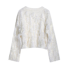 A white, long-sleeved sweater with a textured, fuzzy appearance.