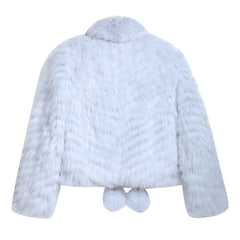 A white fur coat with a collar and pom poms on the bottom.