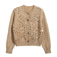 A beige cardigan with a pattern of small black dots or sequins on the front.