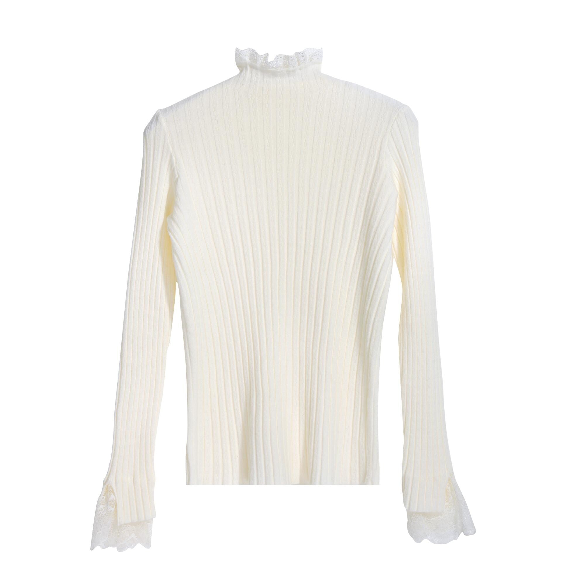 A white long-sleeved sweater with a ruffled collar and lace trim on the sleeves.