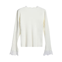 A white long-sleeved shirt with lace trim on the sleeves.