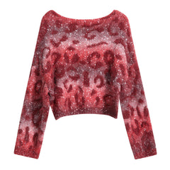 A red and white patterned sweater with a high neck and long sleeves.
