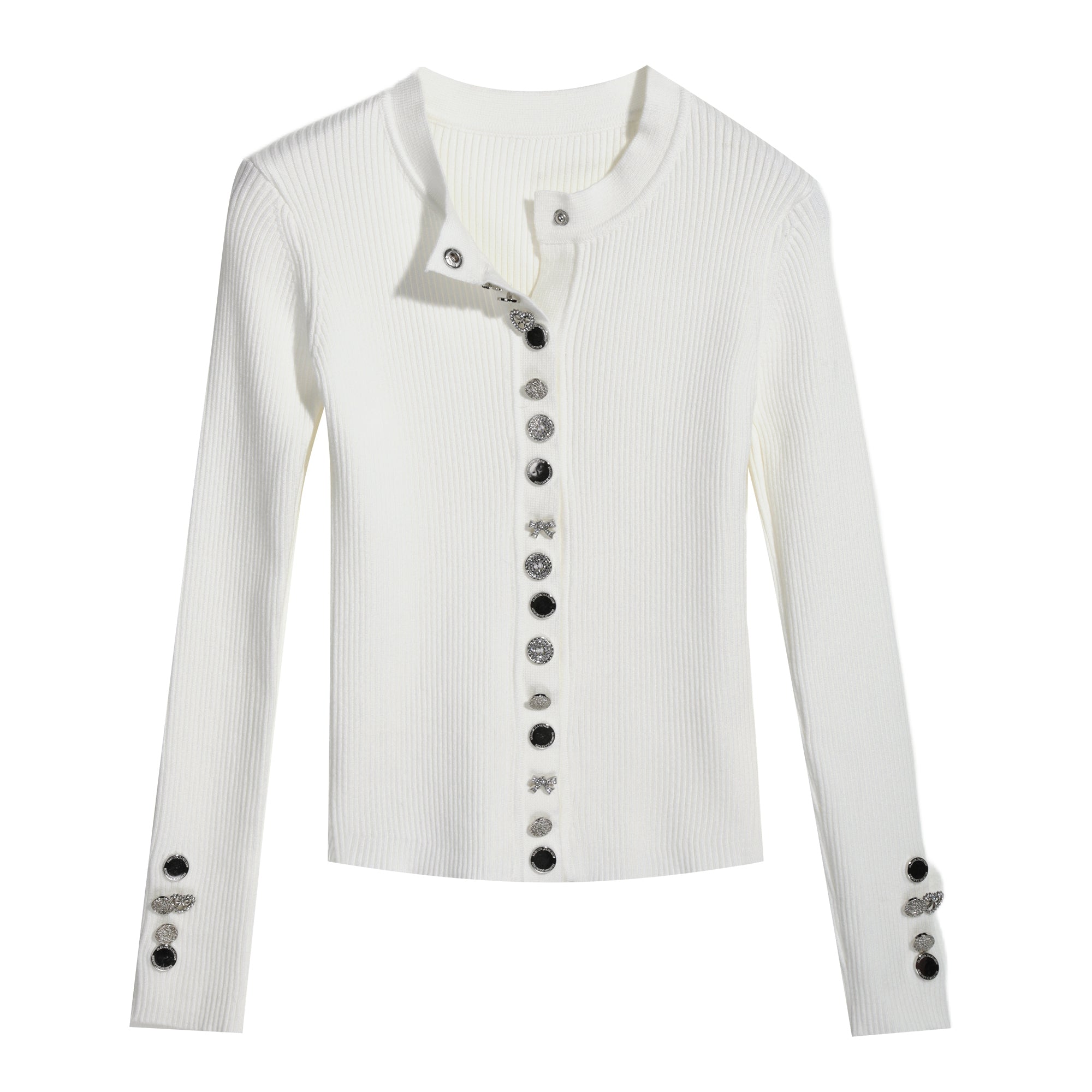A white long-sleeved cardigan with black buttons and embellishments on the sleeves.