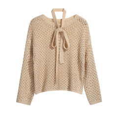 A beige knitted sweater with a tie detail at the neckline.