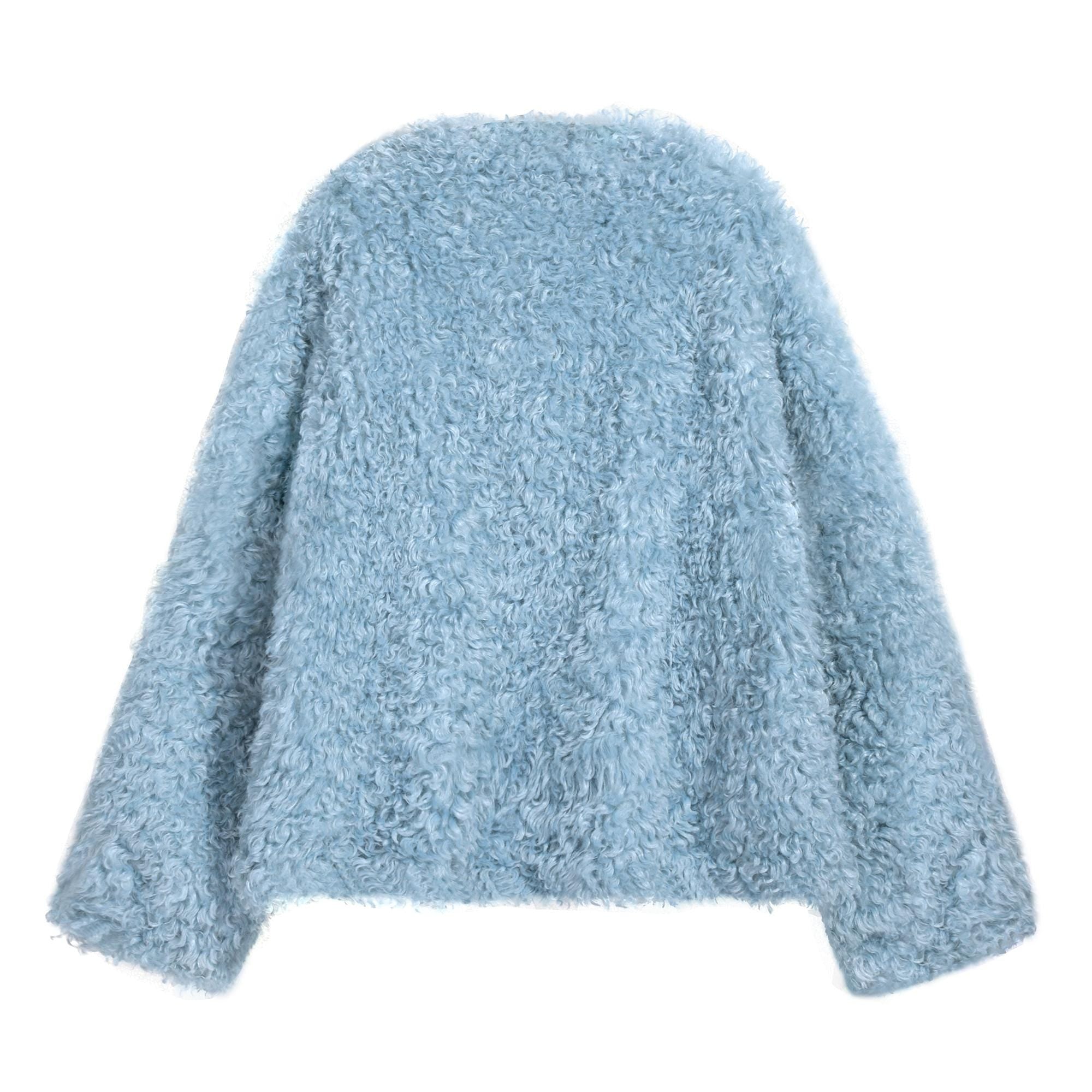 A light blue, fluffy, oversized sweater is shown against a white background.