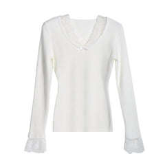A white long-sleeved top with lace trim on the sleeves and collar.