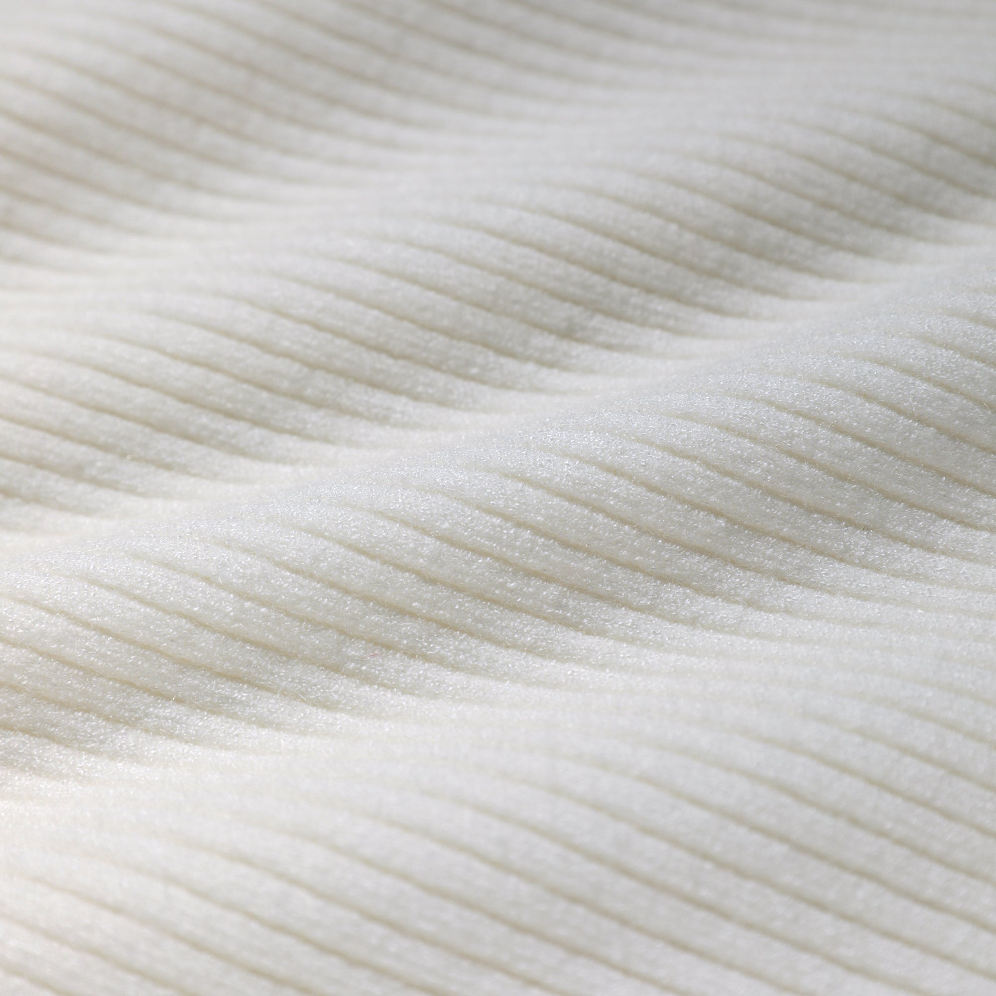 a close-up view of a white fabric with a textured, ribbed appearance.