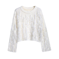 A white, long-sleeved sweater with a textured, fuzzy appearance.