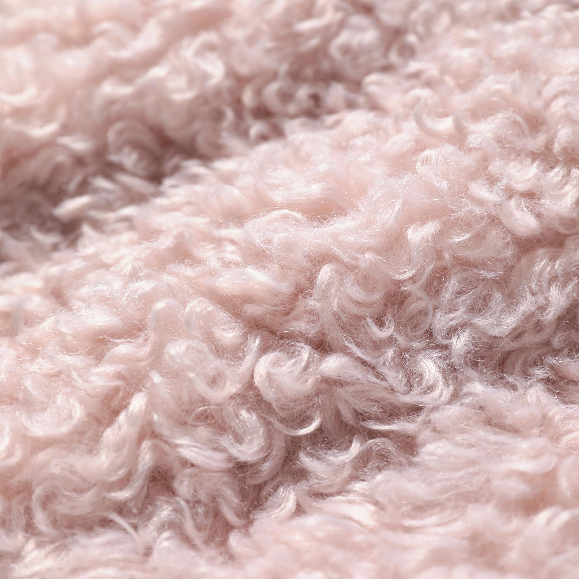 A close-up image of a soft, fluffy, and textured fabric, likely a type of wool or similar material, with a soft pink or light pink hue.