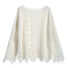 A white, long-sleeved blouse with a lace-like pattern and fringed edges.